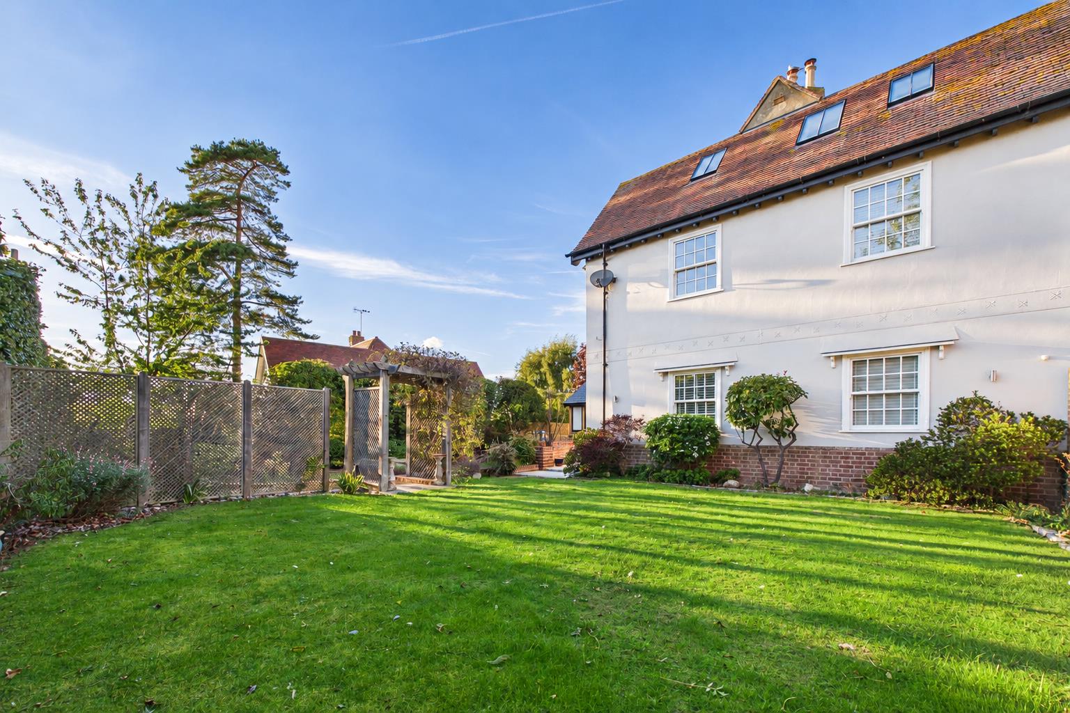 Vibrant English Garden and Cream Stucco House.png